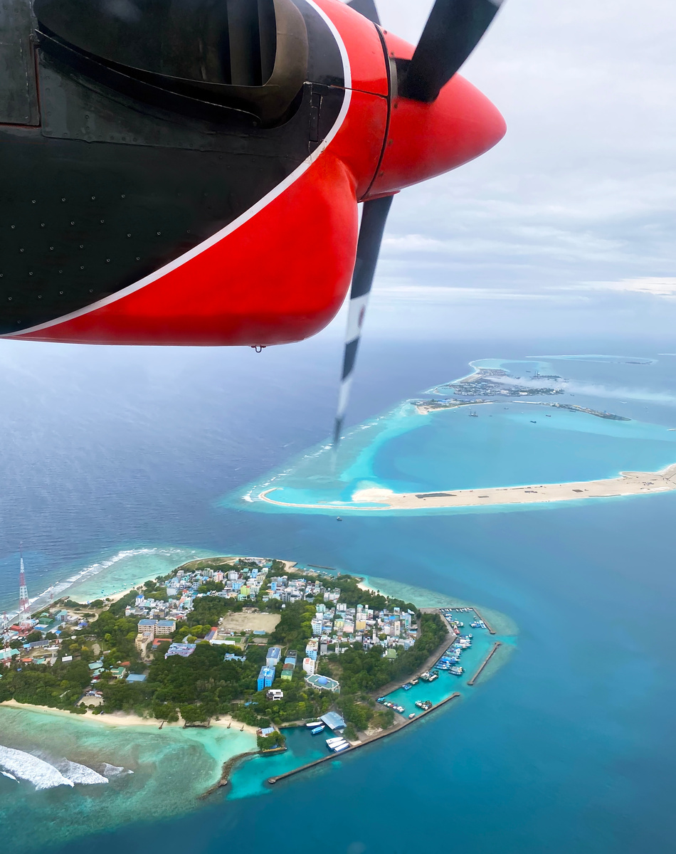 Sea plane flying above Maldives island plane getaway Seaplane