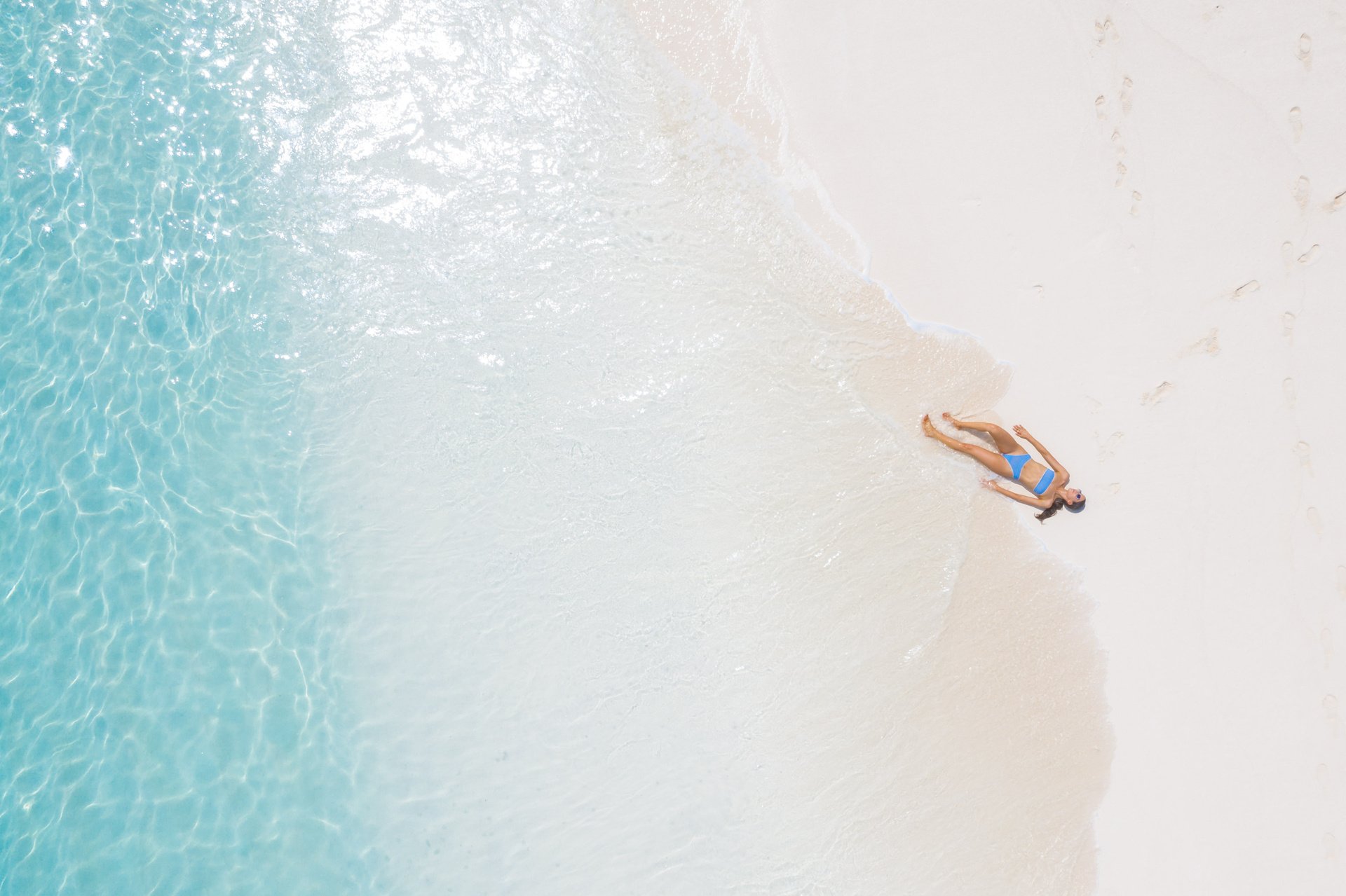 Woman Lying on Seashore